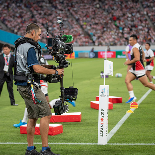 Cameraman producing content at a football match training